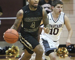 William D. Lewis The vindicator  HArding's Lynn Bowden(4) drives past Boardman's Mark Smaldino(10) during 12022016 action at Boardman.