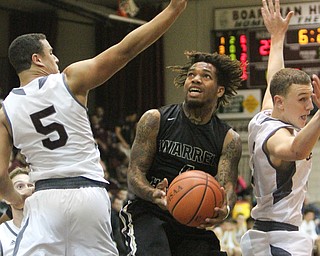 William D. Lewis The vindicator  HArding's Lynn Bowden(4) drives betweenBoardman's Travis Koontz(5) and Holden Lipke(3) during 12022016 action at Boardman.