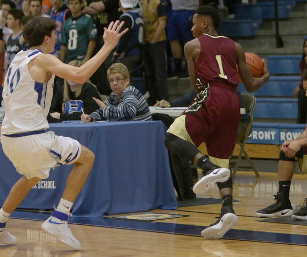Liberty's Andree Bowers saves the ball from goin out of bounds while being defended by Poland's Daniel Kramer (10) during the first half of Friday nights matchup at Poland Seminary High School.  Dustin Livesay  |  The Vindicator  12/3/16  Poland