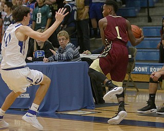 Liberty's Andree Bowers saves the ball from goin out of bounds while being defended by Poland's Daniel Kramer (10) during the first half of Friday nights matchup at Poland Seminary High School.  Dustin Livesay  |  The Vindicator  12/3/16  Poland