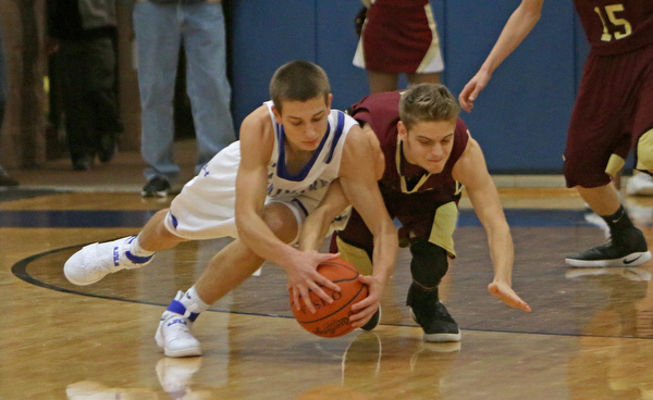Poland's Billy Orr (24) dives for a loose ball with Liberty's Kevin Hawn (3) during the first half of Friday nights matchup at Poland Seminary High School.  Dustin Livesay  |  The Vindicator  12/3/16  Poland