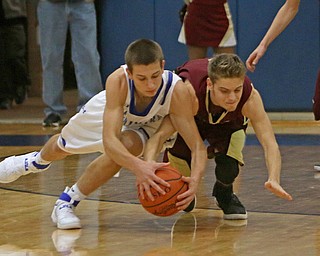 Poland's Billy Orr (24) dives for a loose ball with Liberty's Kevin Hawn (3) during the first half of Friday nights matchup at Poland Seminary High School.  Dustin Livesay  |  The Vindicator  12/3/16  Poland