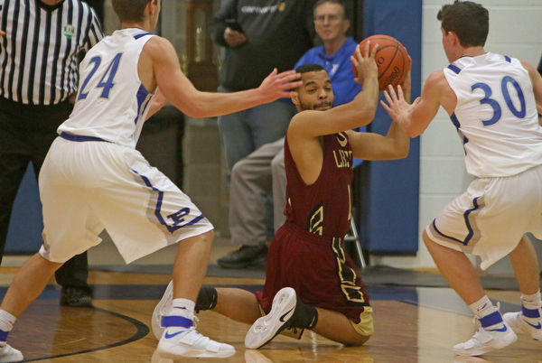 Austin Allison (13) of Liberty looks to pass the ball while being closely defended by Poland's Billy Orr (24) and Kyle Patterson (30) during the first half of Friday nights matchup at Poland Seminary High School.  Dustin Livesay  |  The Vindicator  12/3/16  Poland