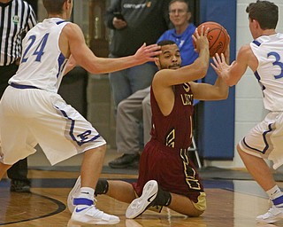 Austin Allison (13) of Liberty looks to pass the ball while being closely defended by Poland's Billy Orr (24) and Kyle Patterson (30) during the first half of Friday nights matchup at Poland Seminary High School.  Dustin Livesay  |  The Vindicator  12/3/16  Poland