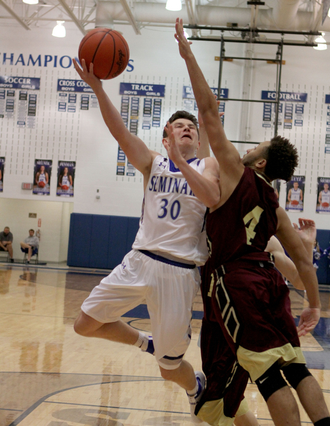 Poland's Kyle Patterson (30) puts up a layup while being defended by Liberty's Kevin Code (4) during the first half of Friday nights matchup at Poland Seminary High School.  Dustin Livesay  |  The Vindicator  12/3/16  Poland