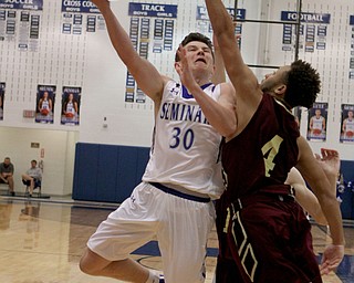 Poland's Kyle Patterson (30) puts up a layup while being defended by Liberty's Kevin Code (4) during the first half of Friday nights matchup at Poland Seminary High School.  Dustin Livesay  |  The Vindicator  12/3/16  Poland