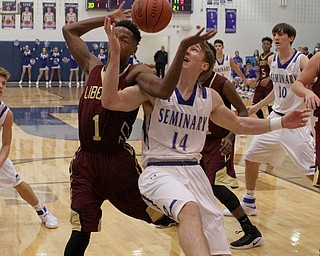 Liberty's Andree Bowers (1) fights for a loose ball with Poland's Konnor Morse (14) during the first half of Friday nights matchup at Poland Seminary High School.  Dustin Livesay  |  The Vindicator  12/3/16  Poland