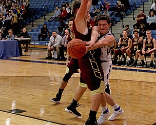Poland's Kyle Patterson (30) tries to pass the ball around the defense set up by Liberty's David Sewell (21) during the first half of Friday nights matchup at Poland Seminary High School.  Dustin Livesay  |  The Vindicator  12/3/16  Poland