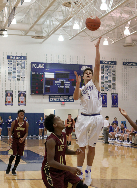 Poland's Braeden O'Shaunghnessy (3) goes up for a jump shot while being defended by Liberty's Daniel Banks (11) during the first half of Friday nights matchup at Poland Seminary High School.  Dustin Livesay  |  The Vindicator  12/3/16  Poland