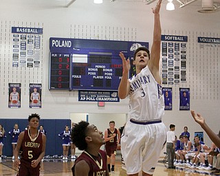 Poland's Braeden O'Shaunghnessy (3) goes up for a jump shot while being defended by Liberty's Daniel Banks (11) during the first half of Friday nights matchup at Poland Seminary High School.  Dustin Livesay  |  The Vindicator  12/3/16  Poland