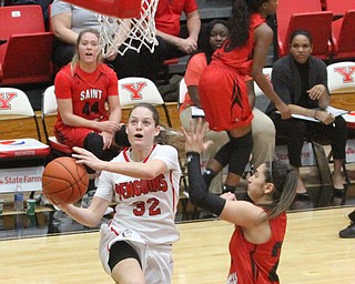 (Nikos Frazier | The Vindicator)..Youngstown State University Penguins senior guard Jenna Hirsch(32) flies though the air for an attempted layup during the first half as Youngstown State University takes on Saint Francis University at the Beeghly Center in Youngstown on Saturday, Dec. 3, 2016.