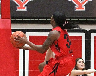 (Nikos Frazier | The Vindicator)..Saint Francis University Red Flash graduate student forward Ace Harrison(34) charges into Youngstown State University Penguins junior guard Kelley Wright(35) during the first half as Youngstown State University takes on Saint Francis University at the Beeghly Center in Youngstown on Saturday, Dec. 3, 2016.