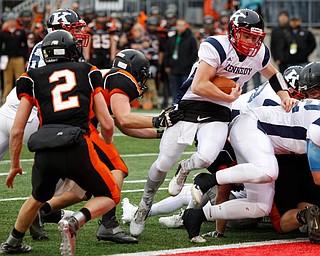 Warren John F. Kennedy's Gregory Valent (4) scores a touchdown past Minster's Isaac Dorsten (53) and Jared Huelsman (2) during the second quarter of the OHSAA Div. VII championship high school football game Saturday, Dec. 3, 2016, in Columbus, Ohio. (Paul Vernon)..