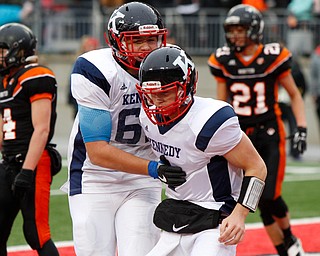 Warren John F. Kennedy's Bruce Johnson (62) celebrates with teammate  Gregory Valent (4) after Valent scored a touchdown against  Minster during the second quarter of the OHSAA Div. VII championship high school football game Saturday, Dec. 3, 2016, in Columbus, Ohio. (Paul Vernon)..