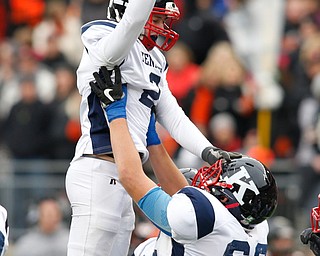 Warren John F. Kennedy's Bruce Johnson (62) celebrates with teammate Justin Bofenkamp (2) after  Bofenkamp's field goal against  Minster during the second quarter of the OHSAA Div. VII championship high school football game Saturday, Dec. 3, 2016, in Columbus, Ohio. (Paul Vernon)..