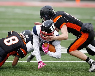 Minster's Alex Lehmkuhl (8), left, and Jared Huelsman (2) stop Warren John F. Kennedy's Hyland Burton (1) during the second quarter of the OHSAA Div. VII championship high school football game Saturday, Dec. 3, 2016, in Columbus, Ohio. (Paul Vernon)..