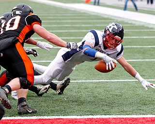 Warren John F. Kennedy's Evan Boyd (7) dives past Minster's Bryce Schmiesing (10) for a touchdown during the third quarter of the OHSAA Div. VII championship high school football game Saturday, Dec. 3, 2016, in Columbus, Ohio. Warren John F. Kennedy won 24-6. (Paul Vernon)..