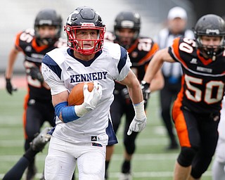 Warren John F. Kennedy's Evan Boyd (7) gets past Minster's Jack Heibrink (25), Austin Brown (21) and Alex Oldiges (50) on his way to a touchdown during the fourth quarter of the OHSAA Div. VII championship high school football game Saturday, Dec. 3, 2016, in Columbus, Ohio. Warren John F. Kennedy won 24-6. (Paul Vernon)..