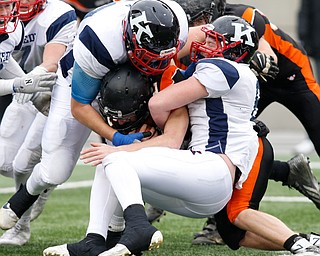 Warren John F. Kennedy's Bruce Johnson (62), left, and teammate John Millard (6) stop Minster's Jared Huelsman (2) during the fourth quarter of the OHSAA Div. VII championship high school football game Saturday, Dec. 3, 2016, in Columbus, Ohio. Warren John F. Kennedy won 24-6. (Paul Vernon)..