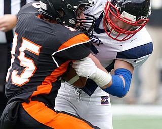 Warren John F. Kennedy's Zach Lewis (55) stops Minster's Jonathan Niemeyer (15) during the fourth quarter of the OHSAA Div. VII championship high school football game Saturday, Dec. 3, 2016, in Columbus, Ohio. Warren John F. Kennedy won 24-6. (Paul Vernon)..