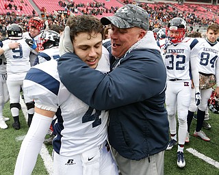 Warren John F. Kennedy assistant coach Jim Campana, right, celebrates with Jacob Coates (44) following the Eagles 24-6 OHSAA Div. VII championship high school football game win over Minster Saturday, Dec. 3, 2016, in Columbus, Ohio. (Paul Vernon)..