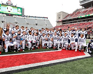 The Warren John F. Kennedy football team is seen following the Eagles 24-6 OHSAA Div. VII championship high school football game win over Minster Saturday, Dec. 3, 2016, in Columbus, Ohio. (Paul Vernon)..