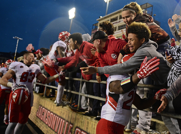 JACKSONVILLE, ALABAMA - DECEMBER 3, 2016: Jameel Smith #26 of YSU is embraced by a YSU fan in the stands after their game Saturday afternoon at Burgess-Snow Field. YSU won 40-24. DAVID DERMER | THE VINDICATOR