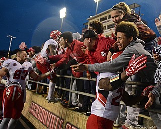 JACKSONVILLE, ALABAMA - DECEMBER 3, 2016: Jameel Smith #26 of YSU is embraced by a YSU fan in the stands after their game Saturday afternoon at Burgess-Snow Field. YSU won 40-24. DAVID DERMER | THE VINDICATOR