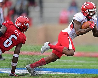 JACKSONVILLE, ALABAMA - DECEMBER 3, 2016: Receiver Alvin Bailey #5 of YSU spins away from defensive back Reggie Hall #6 of Jacksonville State during the first half of their game Saturday afternoon at Burgess-Snow Field. YSU won 40-24. DAVID DERMER | THE VINDICATOR