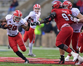 JACKSONVILLE, ALABAMA - DECEMBER 3, 2016: Running back Martin Ruiz #29 of YSU runs the football while avoiding the arm of defensive linemen Desmond Owino #92 of Jacksonville State while he is being blocked by tackle Cameron Fraser #71 during the second half of their game Saturday afternoon at Burgess-Snow Field. YSU won 40-24. DAVID DERMER | THE VINDICATOR