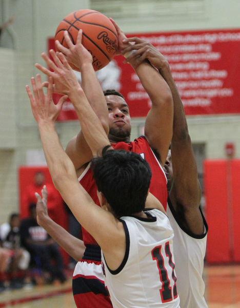 William D. Lewis The Vindicator Fitch's Randy Smith(0) shoots over Struthers' Ethan Vo(11) during 12062016 action at Struthers.