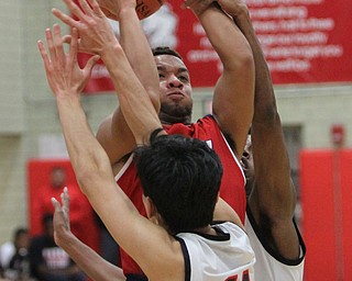 William D. Lewis The Vindicator Fitch's Randy Smith(0) shoots over Struthers' Ethan Vo(11) during 12062016 action at Struthers.