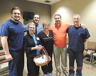 Residents, faculty and staff at Family Practice Center of ValleyCare Northside Medical Center are participating in a fundraising project to provide holiday gifts and fulfill Christmas wishes of many Valley children. They are partnering with E.J. Blott Elementary School teachers and staff who identify the children for the project. Besides gifts for children, each family receives a gift card or voucher for food from Giant Eagle or Walmart. Gretchen Reed, a teacher at E.J. Blott, realized 30 years ago that many children needed clothing, coats, shoes and gifts. She went to her church family and began the outreach. It has grown to include several groups. In front from left, are Sharon Wathen, chairman of Blott Kids holiday project, and  Sheri Griffith, receptionist and organizer of the project at the Family Practice Center. In back are Dr. Roman Davidenko, Dr. Szymon Krzyzanowski, Dr. Steven Swain and Dr. Paul Rich, ValleyCare Medical Group of Ohio Family medicine physicians and lead physicians of the Blott Kids Holiday Project at Northside. SPECIAL TO THE VINDICATOR