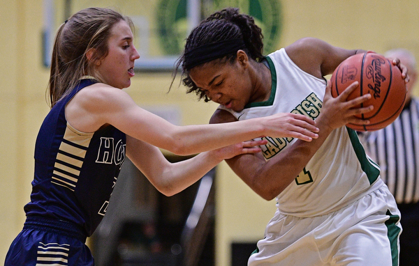 YOUNGSTOWN, OHIO - DECEMBER 7, 2016: Dayshanette Harris #1 of Ursuline protects the ball while Emma Tecca #3 of Hoban goes for the ball during the first half of their game Wednesday night at Ursuline High School. DAVID DERMER | THE VINDICATOR
