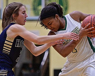 YOUNGSTOWN, OHIO - DECEMBER 7, 2016: Dayshanette Harris #1 of Ursuline protects the ball while Emma Tecca #3 of Hoban goes for the ball during the first half of their game Wednesday night at Ursuline High School. DAVID DERMER | THE VINDICATOR