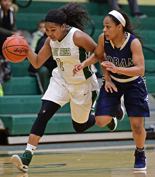 YOUNGSTOWN, OHIO - DECEMBER 7, 2016: Dayshanette Harris #1 of Ursuline drives on Leah Hall #5 of Hoban during the first half of their game Wednesday night at Ursuline High School. DAVID DERMER | THE VINDICATOR