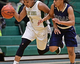 YOUNGSTOWN, OHIO - DECEMBER 7, 2016: Dayshanette Harris #1 of Ursuline drives on Leah Hall #5 of Hoban during the first half of their game Wednesday night at Ursuline High School. DAVID DERMER | THE VINDICATOR