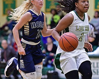 YOUNGSTOWN, OHIO - DECEMBER 7, 2016: Dayshanette Harris #1 of Ursuline looks to the basket while being chased from behind by Rachel Chessar #10 of Hoban during the first half of their game Wednesday night at Ursuline High School. DAVID DERMER | THE VINDICATOR