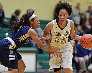 YOUNGSTOWN, OHIO - DECEMBER 7, 2016: Simone Comer #32 of Ursuline drives on drives on Leah Hall #5 of Hoban during the second half of their game Wednesday night at Ursuline High School. DAVID DERMER | THE VINDICATOR