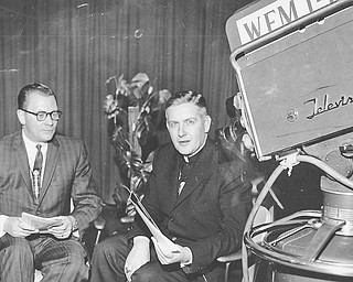 01251962 Malone Rev James Malone, right interviewed by Mitchell F. Stanley WFMJ station mgr on Channel 21's Spotlight program. the topic is What is a catholic? This was the first time a a bishop of the Youngstiownb Diceses appeared ona informal interview program.