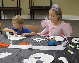 Neighbors | Alexis Bartolomucci.Children created their own ghost craft during the Halloween Howls event at the Poland library on Oct. 25.