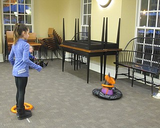 Neighbors | Alexis Bartolomucci.One of the children at the Halloween Howls program at the Poland library on Oct. 25 played the witch hat ring toss.
