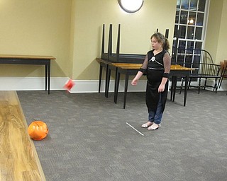 Neighbors | Alexis Bartolomucci.Shayla played the pumpkin bean bag toss game during the Halloween Howls program at the Poland library on Oct. 25.