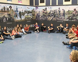 THE VINDICATOR ||  Ronald Smith, president of The Spirit of America’s Story, explains the organization’s 100-foot-long mural to Austintown Middle Schools students on Pearl Harbor Day 2016. The mural depicts scenes of America’s military involvement from the Revolutionary War to the war on terror.