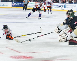Scott R. Galvin | Vindicator.Youngstown Phantoms forward Tommy Apap (21) takes a shot against Muskegon Lumberjacks goalie Keith Petruzzelli (29) during overtime at the Covelli Centre on Dec. 8, 2016. The Phantoms lost 4-3 in overtime.