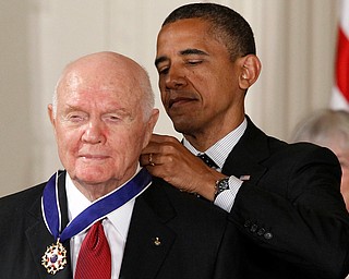 FILE - In this Tuesday, May 29, 2012, file photo, President Barack Obama awards the Medal of Freedom to former astronaut John Glenn during a ceremony in the East Room of the White House in Washington. Glenn, the first American to orbit Earth who later spent 24 years representing Ohio in the Senate, died Thursday, Dec. 8, 2016, at the age of 95. (AP Photo/Charles Dharapak, File)