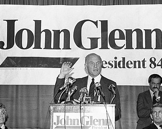 FILE - In this Tuesday, Jan. 18, 1984 file photo, Sen. John Glenn, D-Ohio, answers questions from the press in Jackson, Miss. At left is his wife, Annie Glenn. Glenn travelled through the South seeking support for his presidential campaign. Glenn, the first U.S. astronaut to orbit Earth who later spent 24 years representing Ohio in the Senate, died Thursday, Dec. 8, 2016, at the age of 95. (AP Photo/Tannen Maury, File)