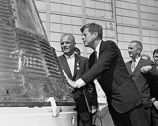 FILE - In this Feb. 23, 1962 file photo, astronaut John Glenn and President John F. Kennedy inspect the Friendship 7, the Mercury capsule in which Glenn became the first American to orbit the Earth. Kennedy presented Distinguished Service medal to Glenn at Cape Canaveral, Fla. At right is Vice President Lyndon Johnson. Glenn, who later spent 24 years representing Ohio in the Senate, has died at 95. (AP Photo/Vincent P. Connolly, File)