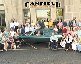 SPECIAL TO THE VINDICATOR
Canfield High School Class of 1966 gathered Sept. 10 for its 50th reunion. To the left of the car, seated in front, are Sue Nelson Latess, Carol Morelli Creps, Bonnie Anderson Kellett, Carol Platek Swartz, Marilee Hedge Morrison and Kathy Gillespie Tomajko. Seated in the second row on the left are Suzanne Rowan Adair, Kendra Moser, Nancy Hubbard Diehl, Thelma Martz Wise and Sharyn Mitchell Staffrey. The driver of the car is Dale Rhinehart. To the right of the car, seated in front, are Tim Calvin, Pam Stephens, Susan Shorten, Candice Stephenson, Carol Abblett Ryan and Shirley Hendricks Metzger. Seated in the second row on the right are Marylynn Miller Savage, Cheryl Fulcomer Kriska, Kate Patterson Greenwald, Sheila Stickel, Marilyn Myers Murphy, Margie Kelbaugh Lefler and Judy Baer Leatherman. Standing in front on the steps, are Karen Hoover, Nancy Henry Haraburda, Bill Watkins, Tim Williams, Bob Mayle, Janet Shotts Anderson, Linda Bretschneider Mallue and Jane Harstine Weigel. And in back are Bob Farr, Bob Minkler, Wynn Reuter, Paul McKnight, Jim Clay, Rick Calvin, Tony Belfast, Craig Ligibel, Gregory Rochow, Ed Anderson, Eric Anderson, Jim Swartz and Mark Nelsons, Gary Bowden and Bill Popio.