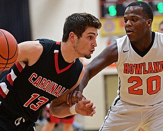 HOWLAND, OHIO - DECEMBER 9, 2016: Jared Clark #13 of Canfield drives on Samari Dean #20 of Howland during the first half of their game Friday night at Howland High School. DAVID DERMER | THE VINDICATOR